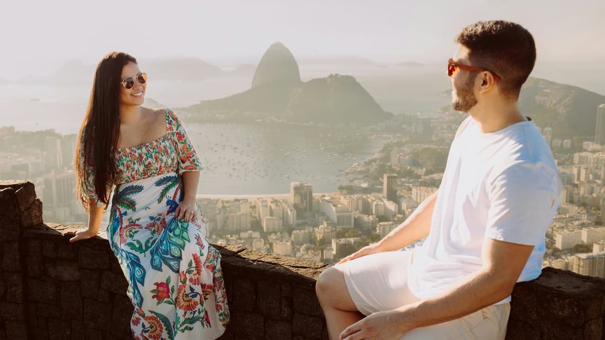 A happy couple enjoying the panoramic view of Rio de Janeiro's iconic skyline.