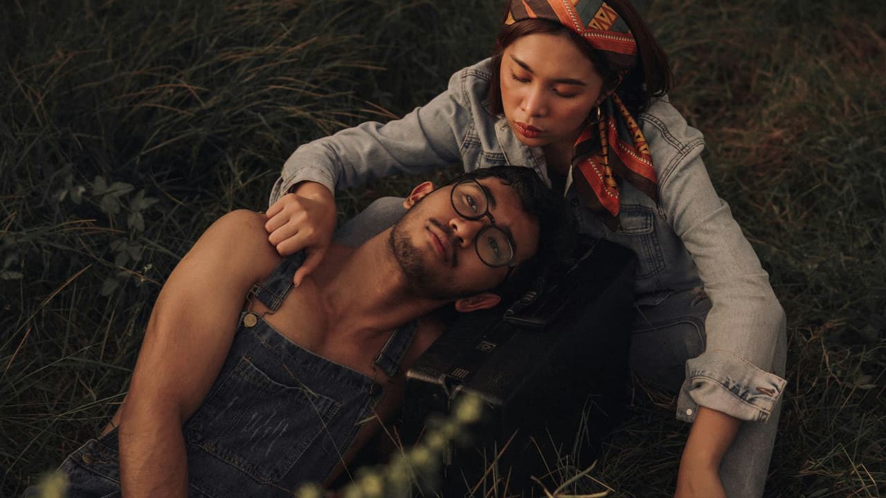 A couple sharing a tender moment outdoors, embodying romance and leisure in a fall setting.
