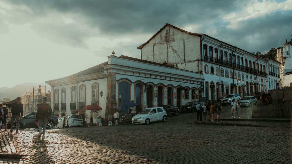Sunlit historic town square with cobblestone streets and classic architecture.