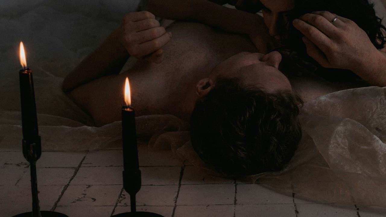 Romantic scene of a loving couple embracing by candlelight, creating a warm, intimate atmosphere.